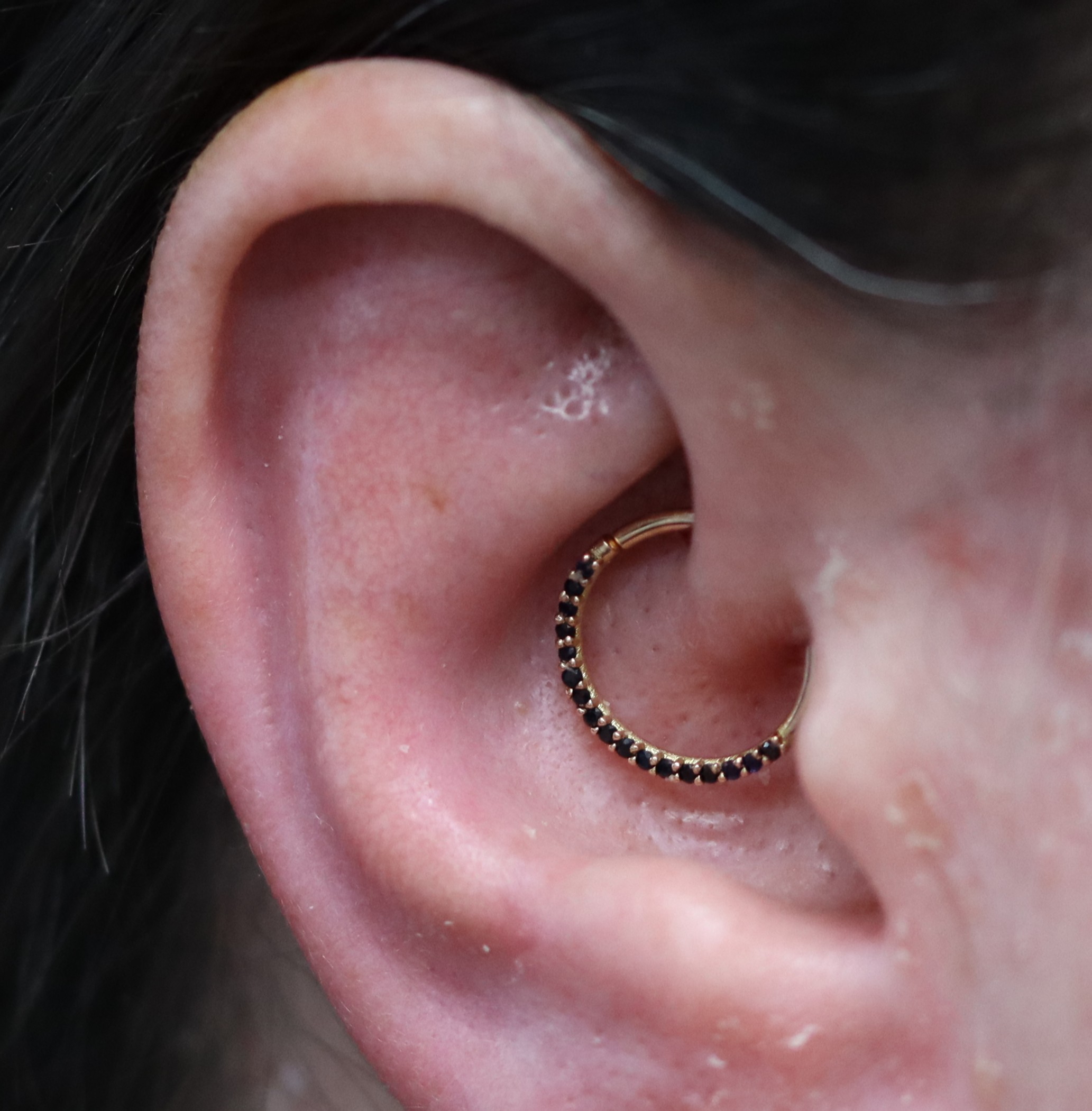 Daith piercing with 18k rose gold and black sapphire Suspiria ring from Ixus Fine Jewellery