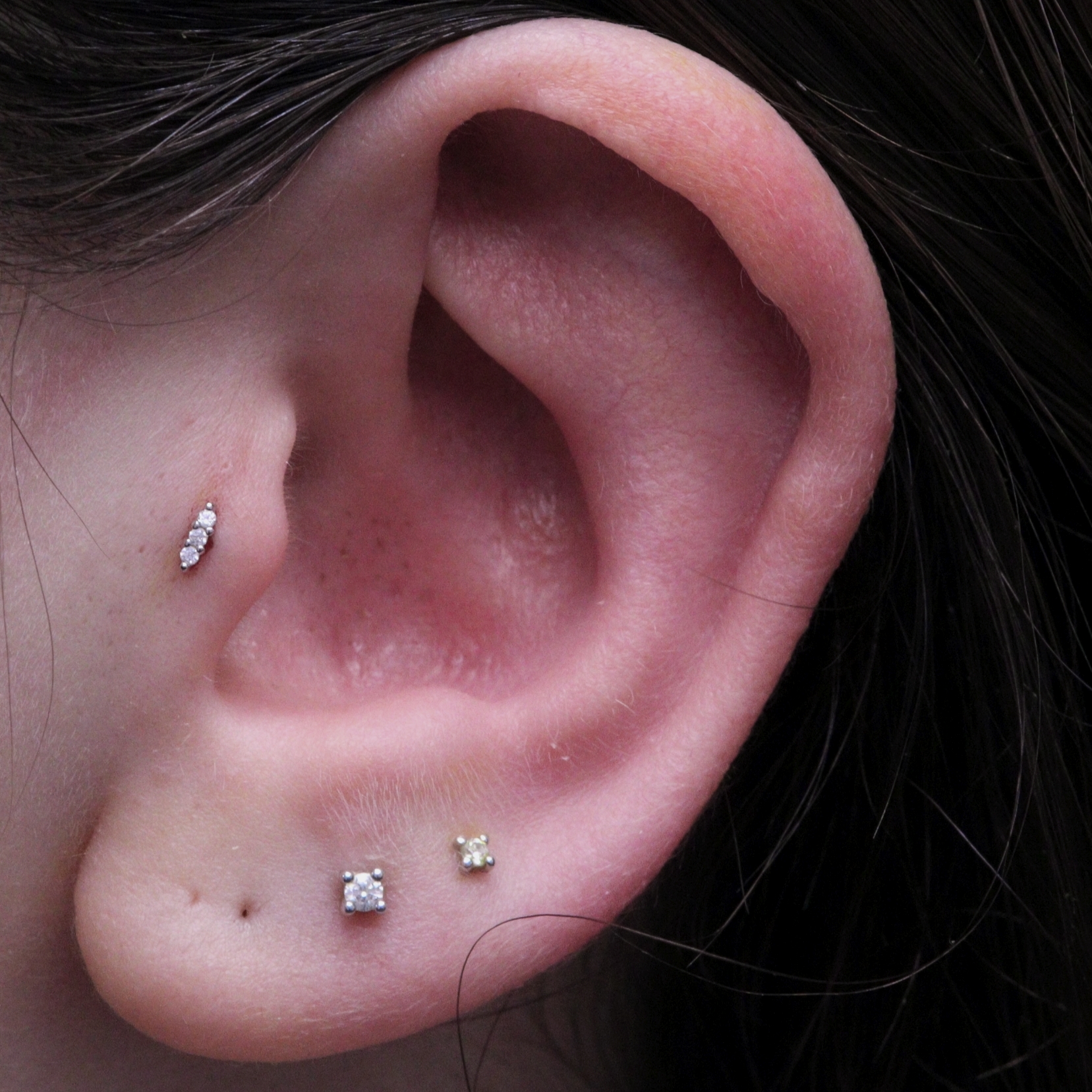 Tragus piercing with solid gold and moissanite Venus end from Ixus Fine Jewellery