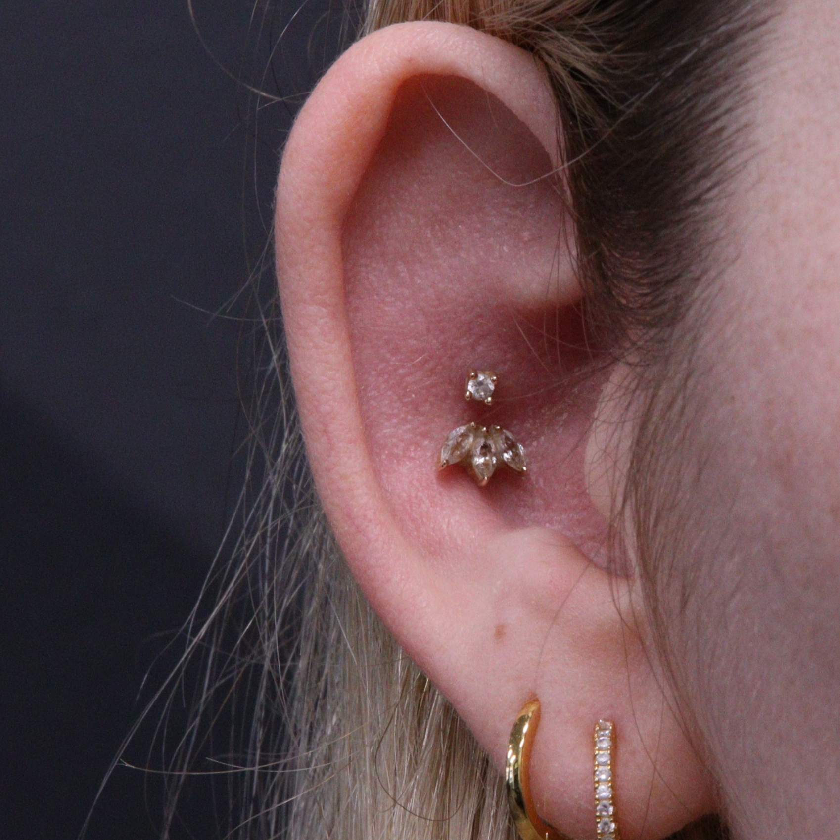 Double conch piercing with 14k gold jewellery