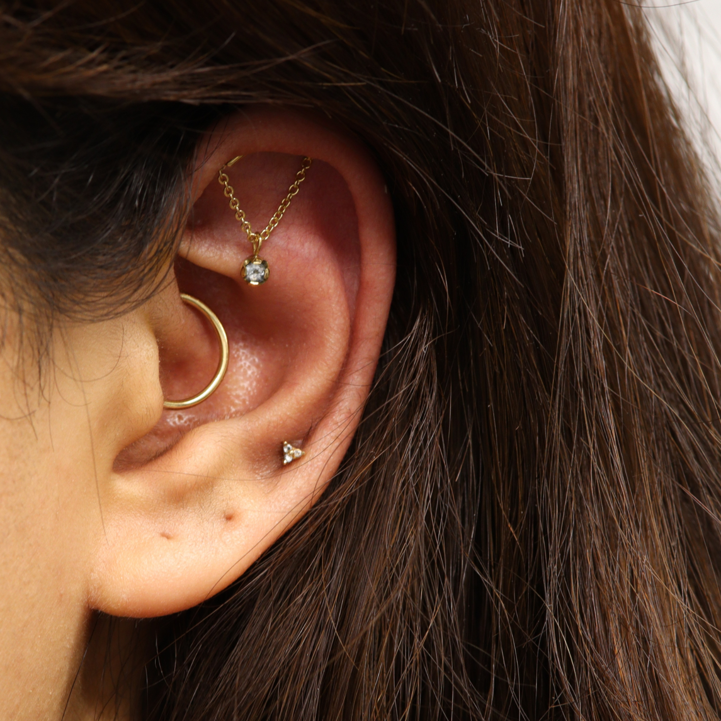 Hidden helix, daith and low helix piercings with 18k gold jewellery from Ixus Fine Jewellery