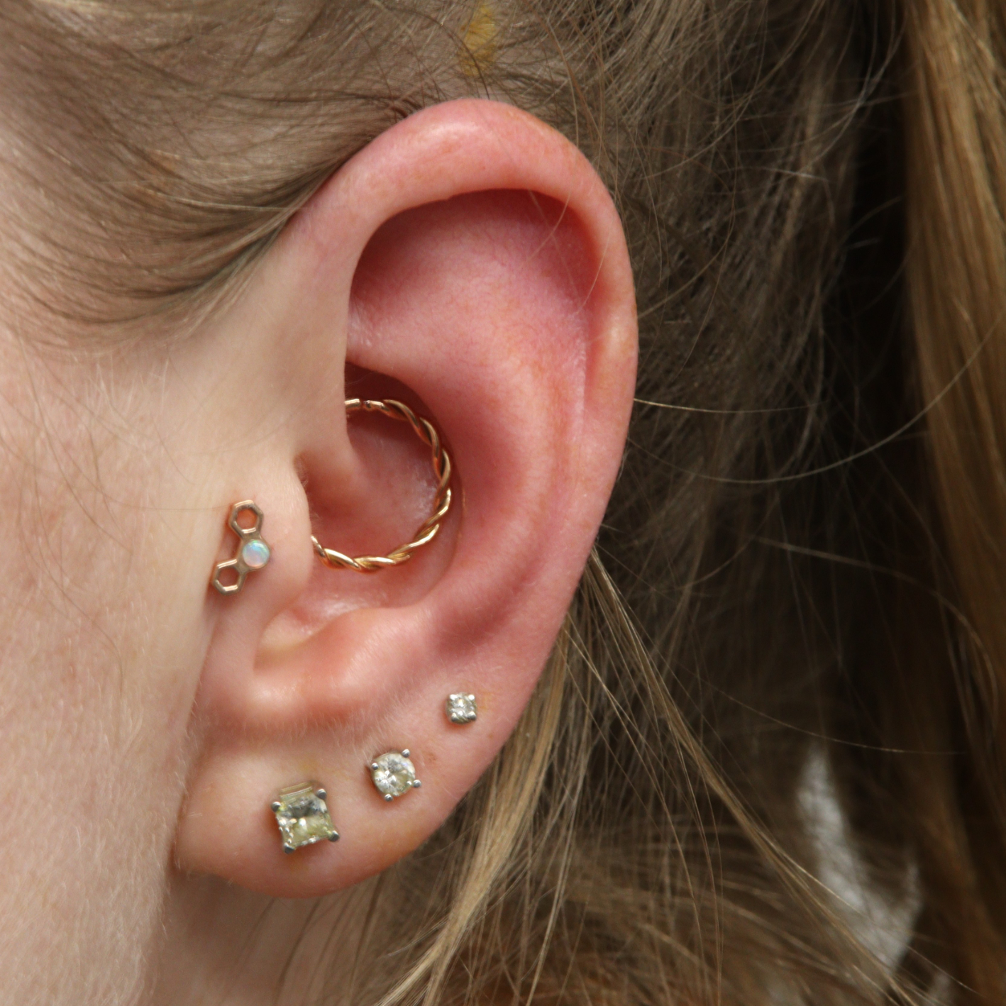 Daith piercing with jewellery from Ixus fine jewellery and Tragus piercing with jewellery from BVLA