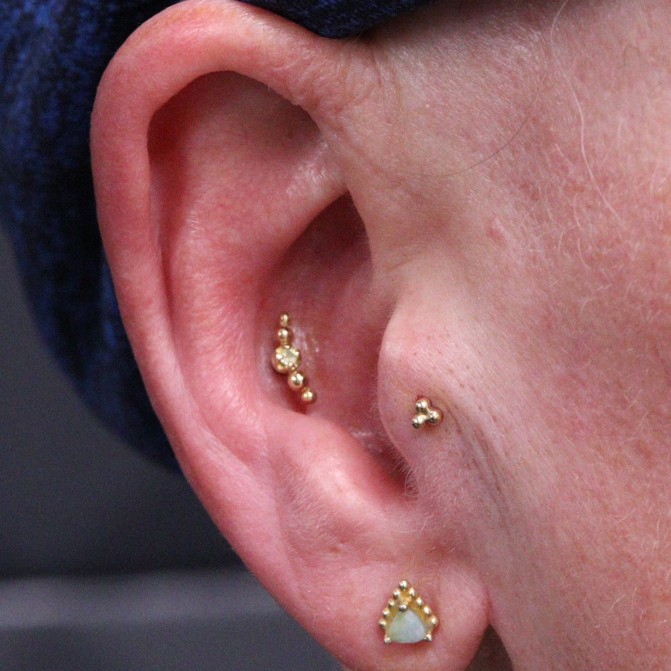 Conch & Tragus piercings with solid 18k gold jewellery from Ixus fine jewellery