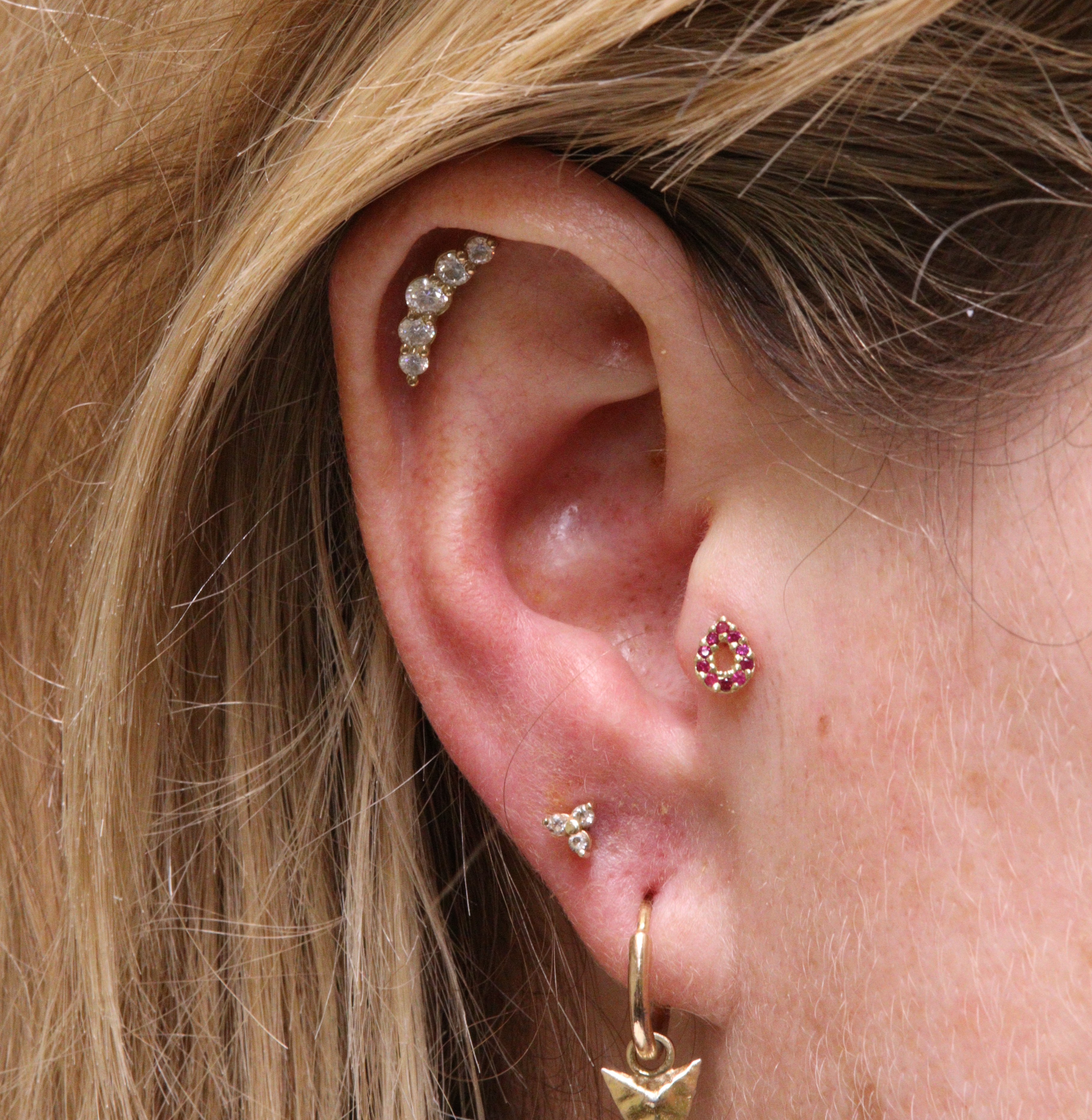 daith piercig with Oddity by Ixus Fine Jewellery in 18k yellow gold with a garnet pear and moissanite accents